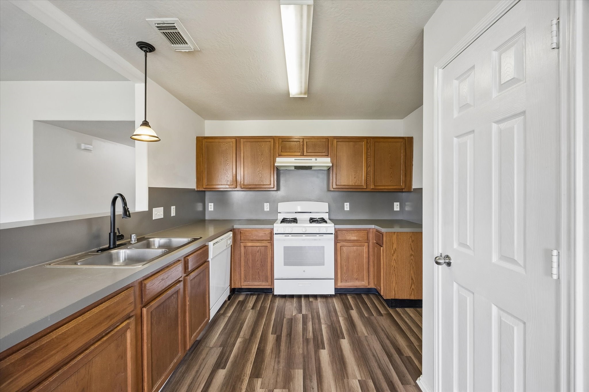 2614 Balsam Ridge Way Fresno, TX 77545 - Photo 6 of 14 a kitchen with a sink stove and cabinets