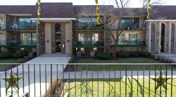 a view of a brick house with large windows