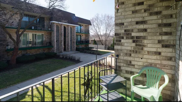a front view of a house with a yard balcony