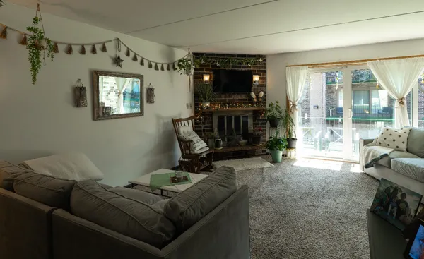 a living room with furniture and a chandelier
