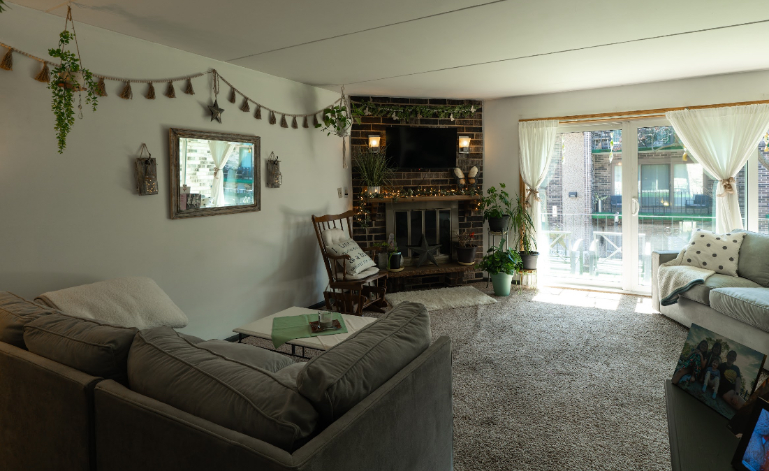9140 South Pulaski Road, Unit 1W Oak Lawn, IL 60453 - Photo 4 of 17 a living room with furniture a flat screen tv and a floor to ceiling window