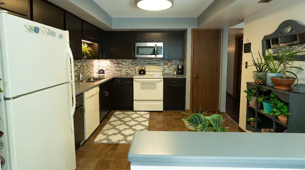 a kitchen with refrigerator and cabinets