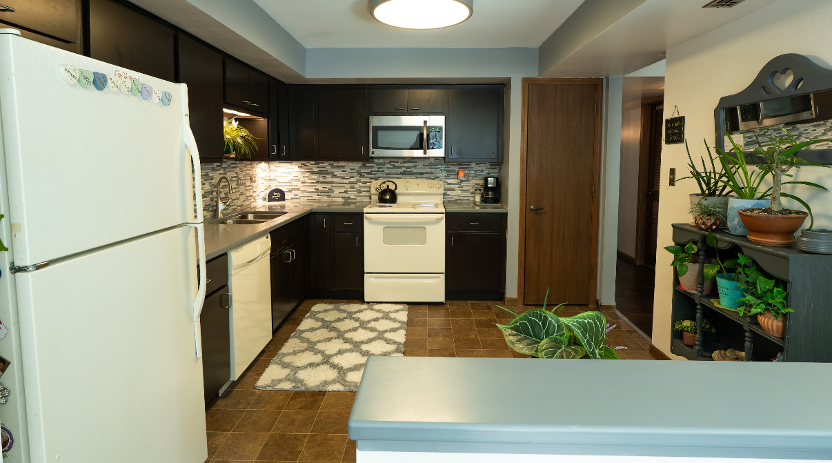 9140 South Pulaski Road, Unit 1W Oak Lawn, IL 60453 - Photo 8 of 17 a kitchen with stainless steel appliances granite countertop a refrigerator and a stove
