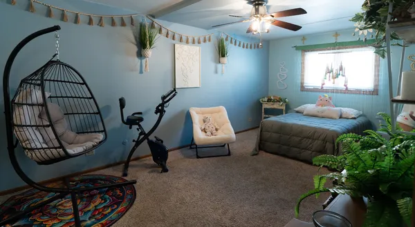 a bedroom with a bed chair and a window