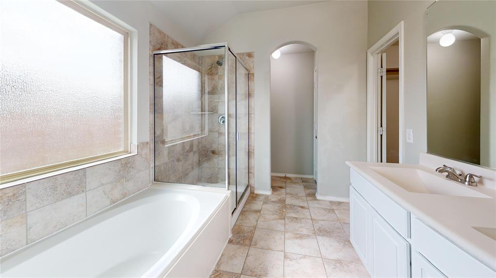 3101 Buckthorn Street Forney, TX 75126 - Photo 18 of 40 Bathroom featuring a white bathtub, a glass-enclosed shower, and a single vanity with an integrated sink
