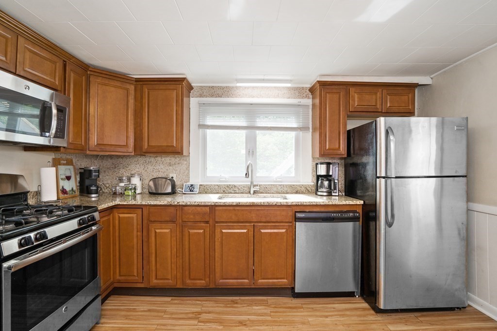 462-464 Gleasondale Road Stow, MA 01775 - Photo 8 of 36 a kitchen with stainless steel appliances granite countertop a sink stove and refrigerator