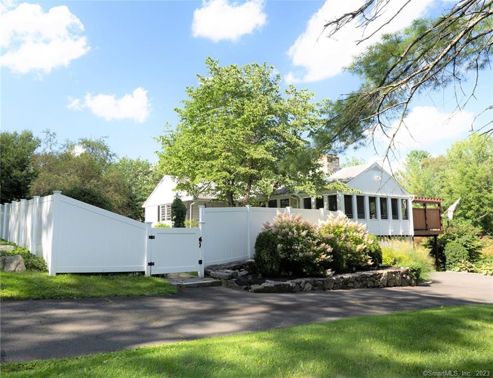 410 North Salem Road Ridgefield, CT 06877 - Photo 1 of 1 a front view of house with yard and trees in the background