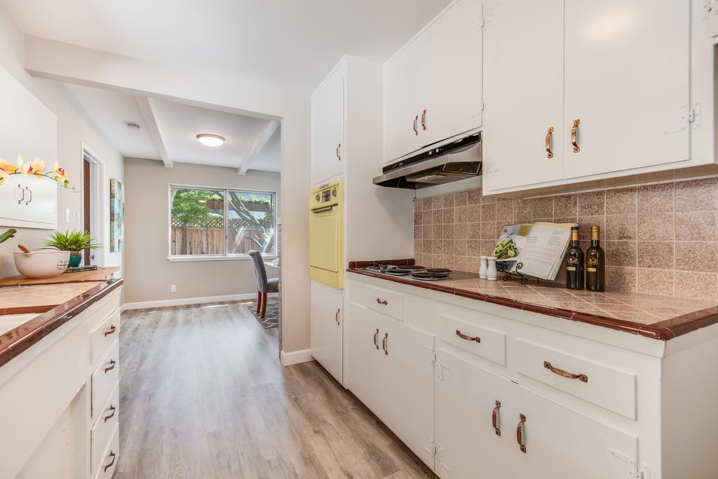 16239 Jacaranda Way Los Gatos, CA 95032 - Photo 7 of 20 a kitchen with granite countertop white cabinets and white appliances