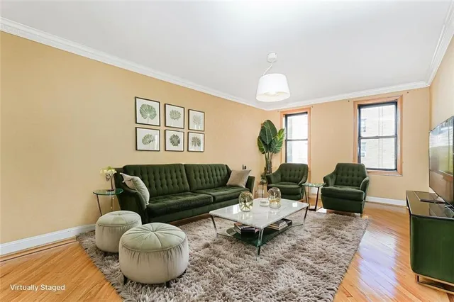 a living room with furniture potted plant a fireplace and a large window