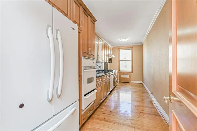 a kitchen with stainless steel appliances a refrigerator and a stove