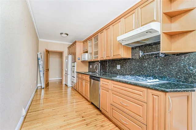 a kitchen with granite countertop a sink and cabinets