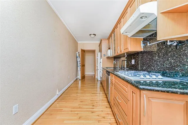 a view of kitchen with granite countertop lots of counter top space