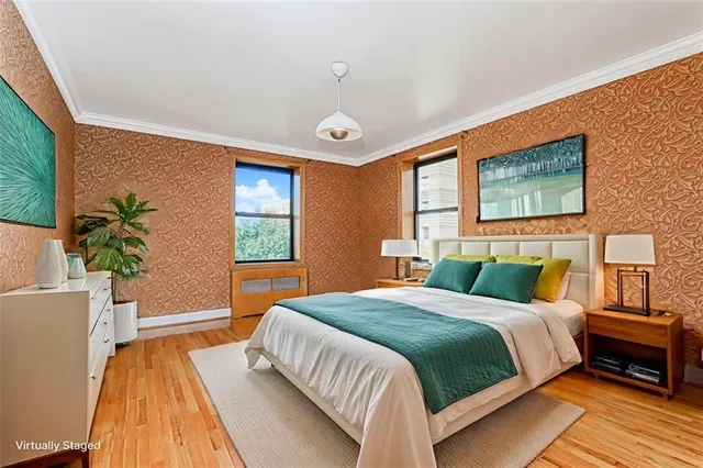 a bedroom with a bed and a potted plant