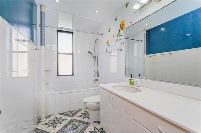 a spacious bathroom with a sink a toilet and shower