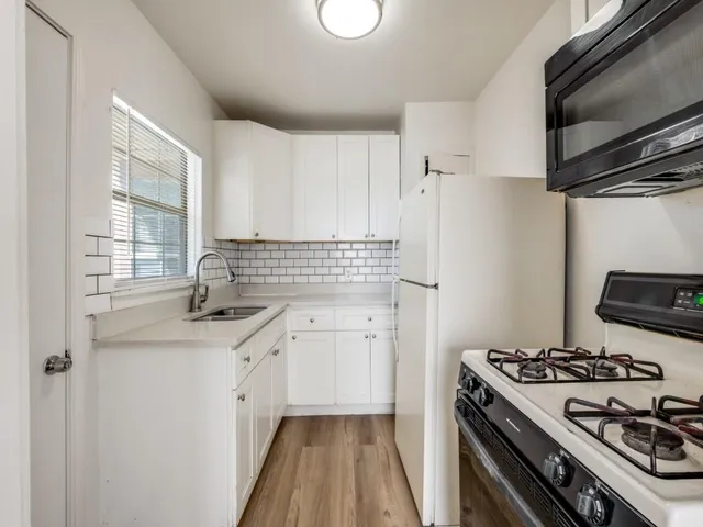 a kitchen with a sink cabinets and window