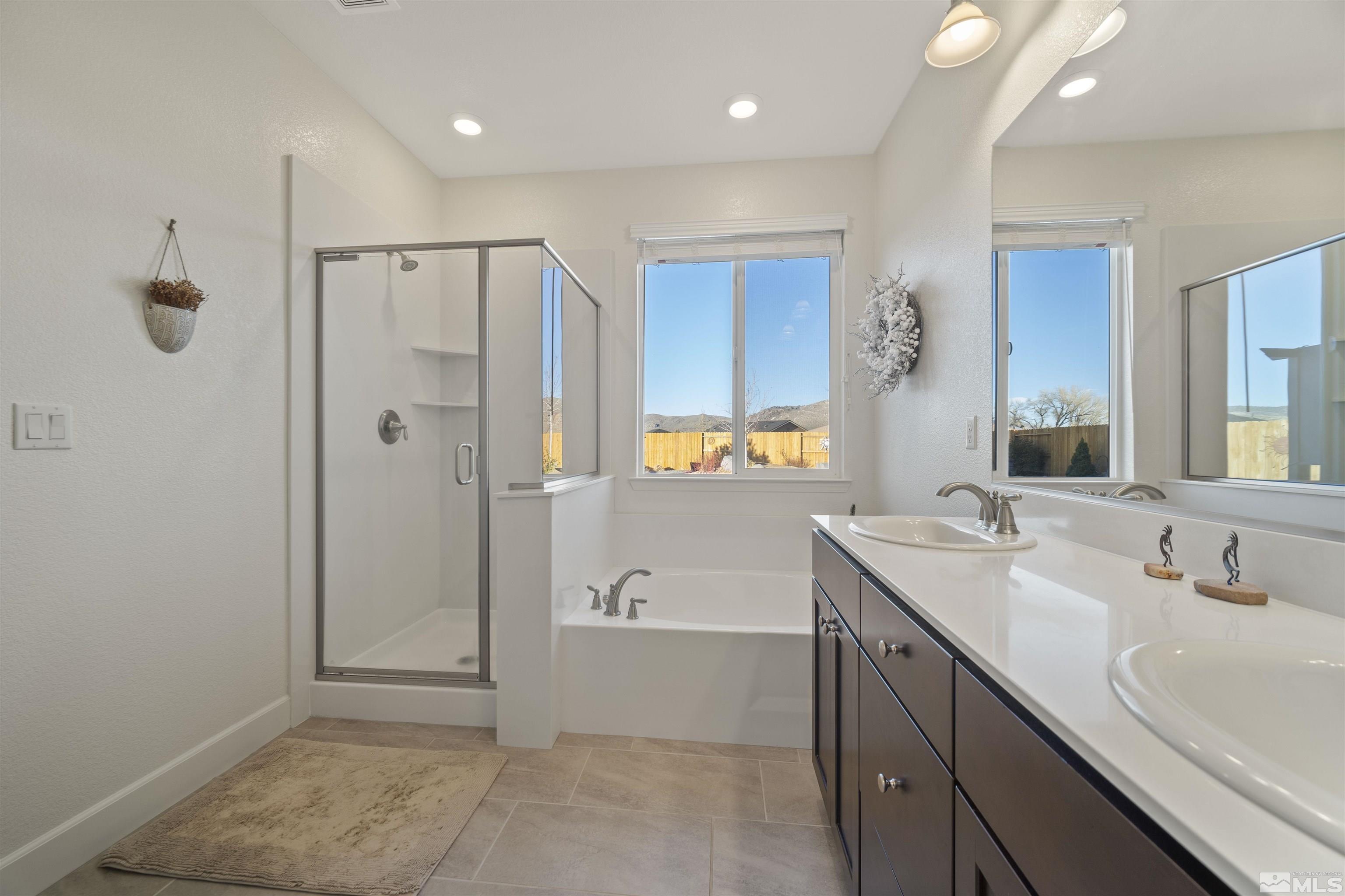 6713 Eagle Peak Drive Carson City, NV 89701 - Photo 22 of 40 a bathroom with a shower sink and mirror