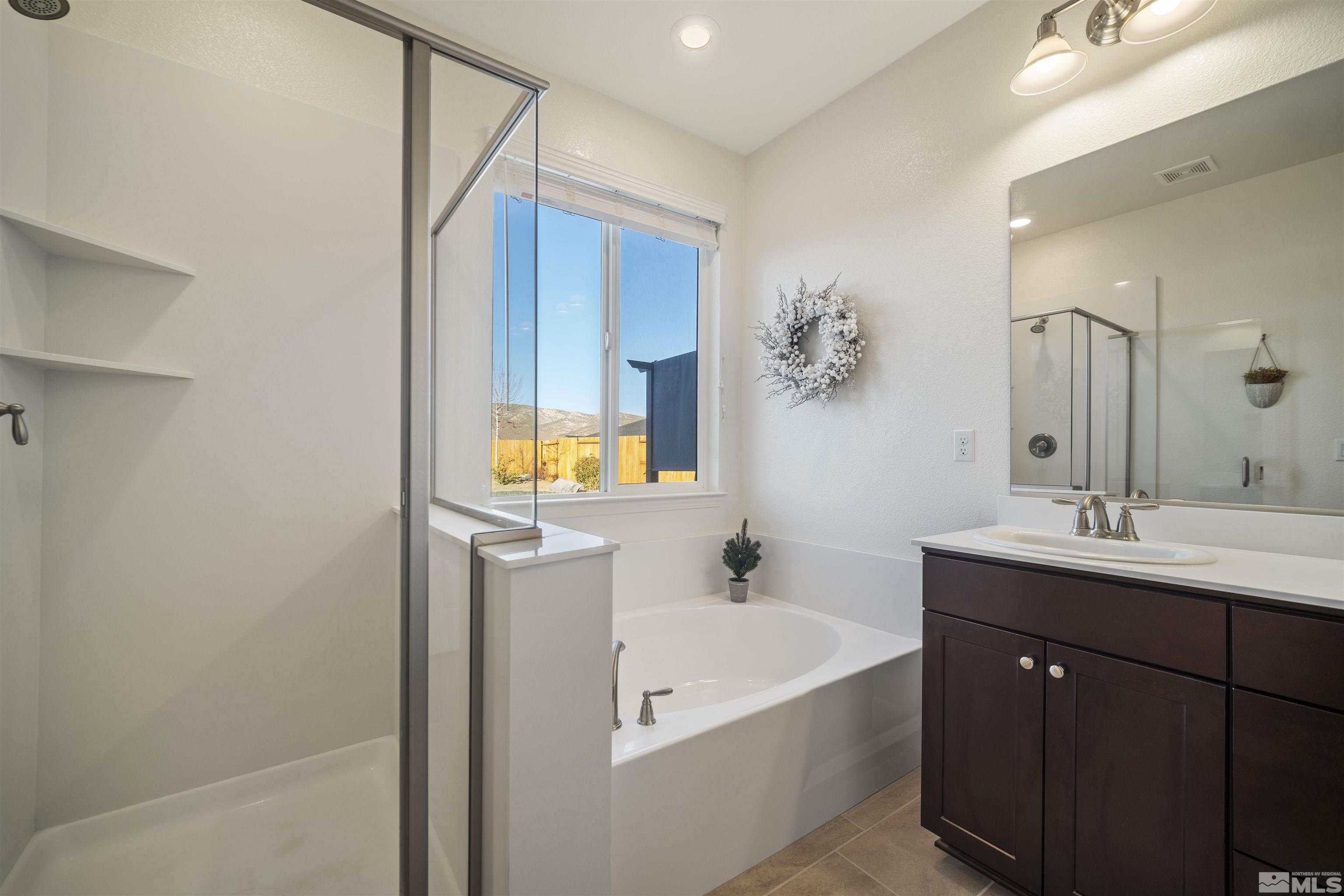 6713 Eagle Peak Drive Carson City, NV 89701 - Photo 23 of 40 a bathroom with a tub sink and mirror