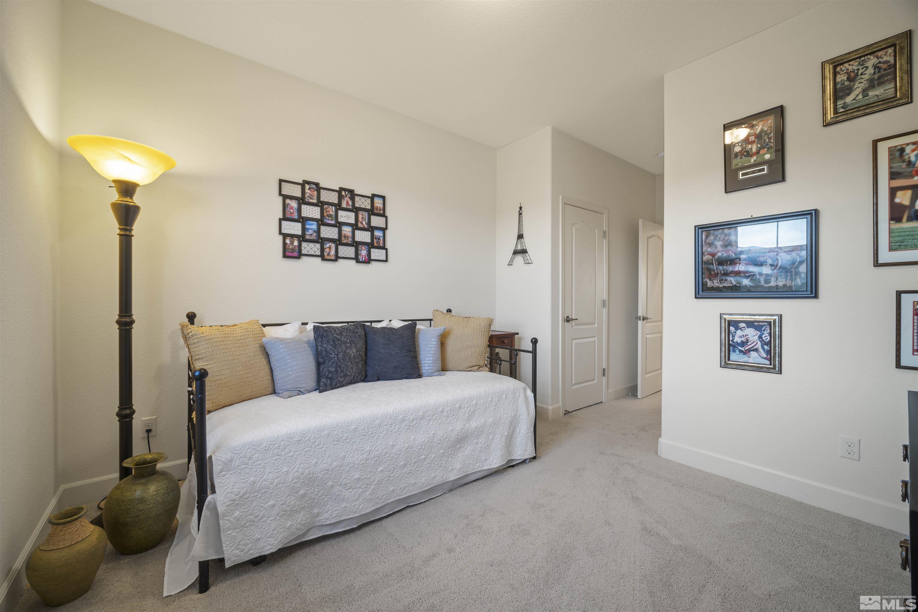 6713 Eagle Peak Drive Carson City, NV 89701 - Photo 28 of 40 a bedroom with a bed and a lamp