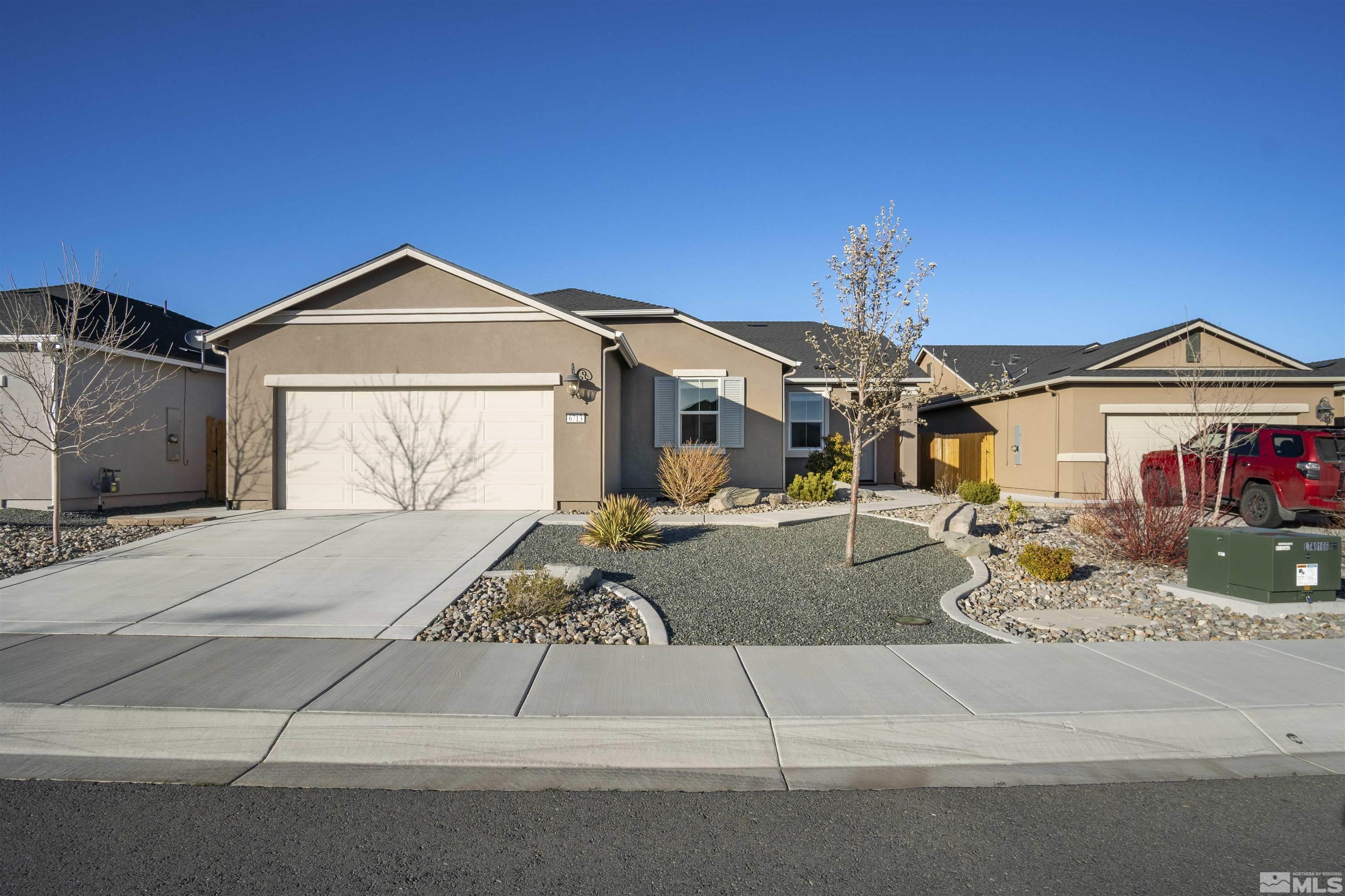 6713 Eagle Peak Drive Carson City, NV 89701 - Photo 3 of 40 a front view of a house with garden