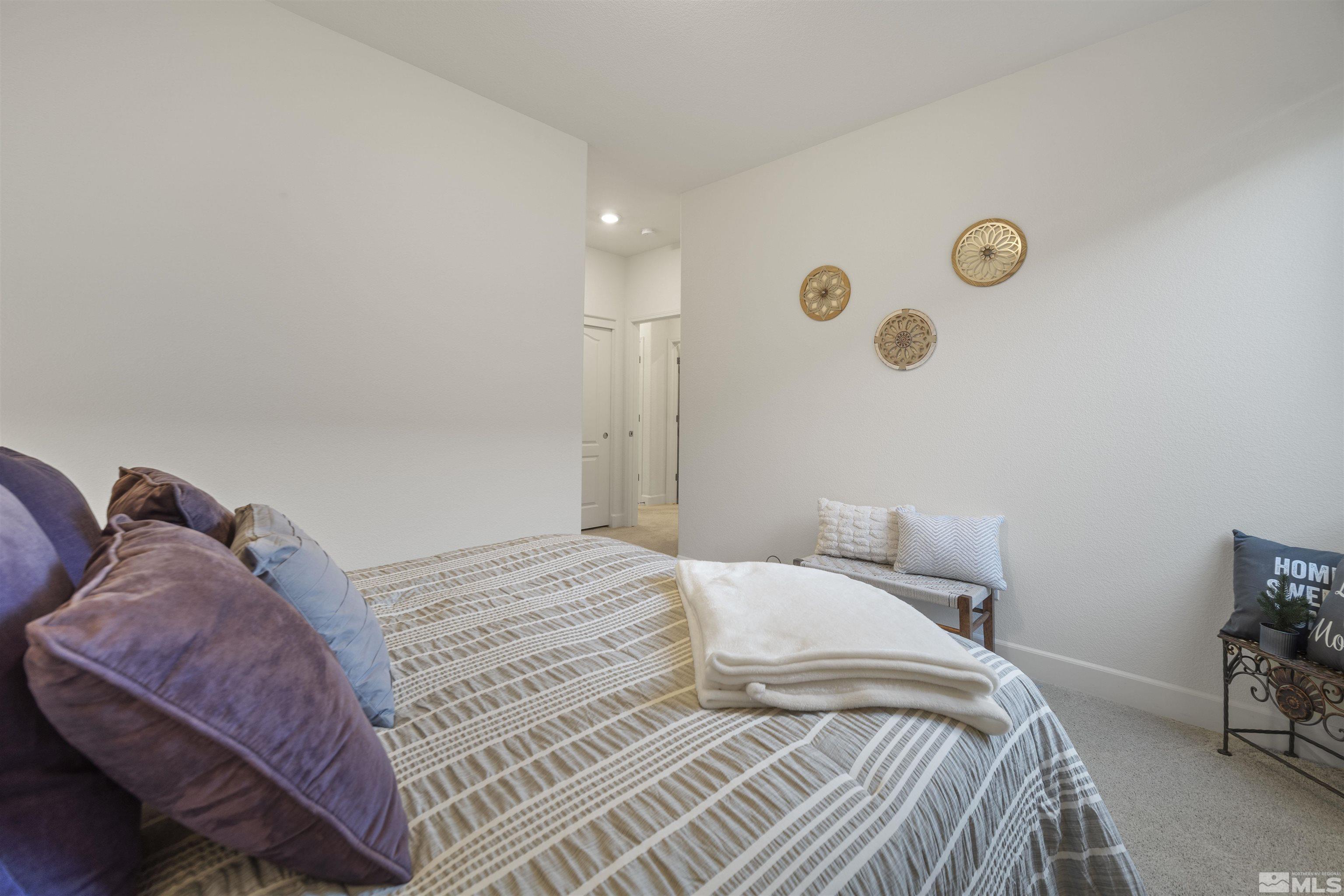 6713 Eagle Peak Drive Carson City, NV 89701 - Photo 31 of 40 a bedroom with a bed and a chair