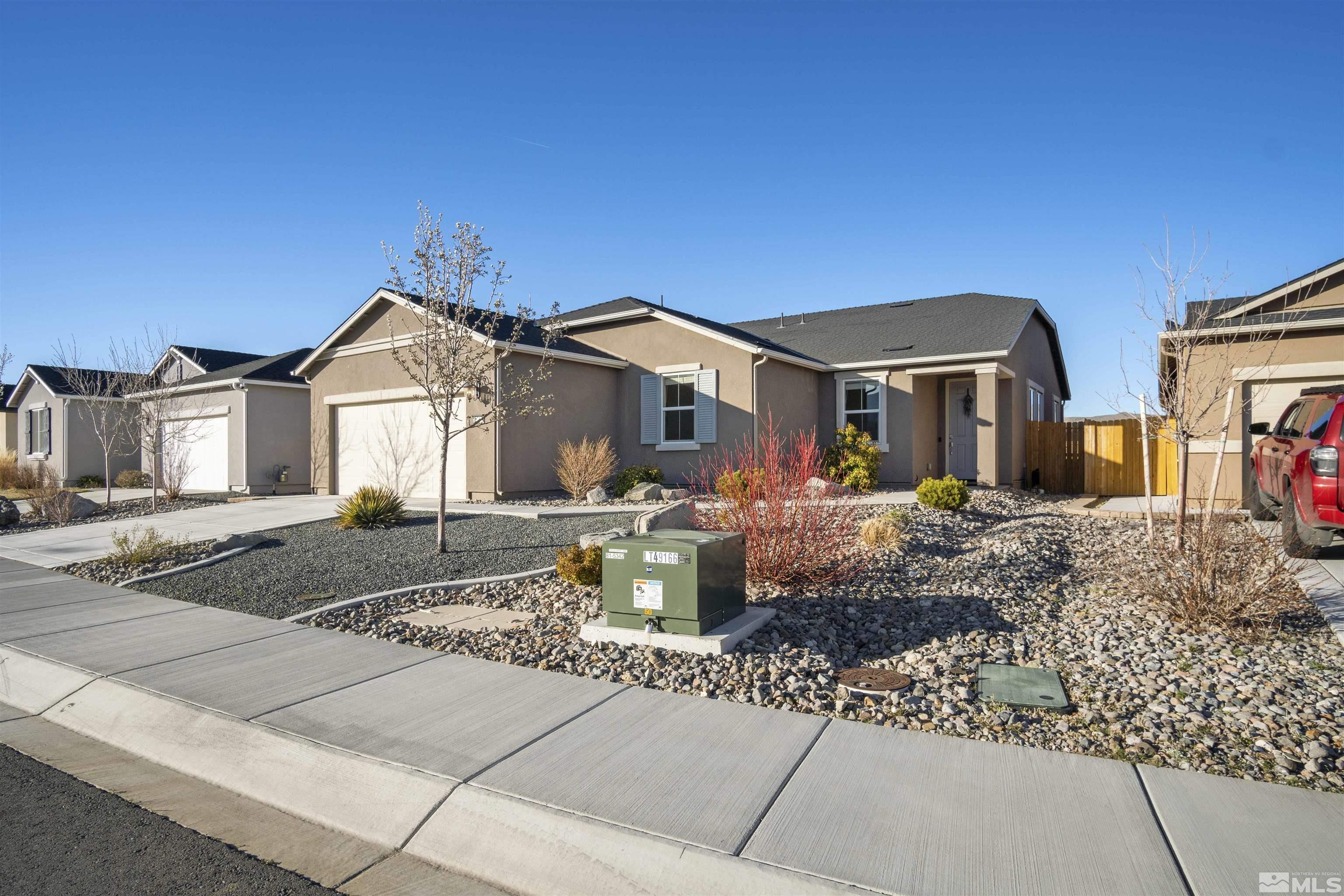 6713 Eagle Peak Drive Carson City, NV 89701 - Photo 4 of 40 a front view of a house with a yard