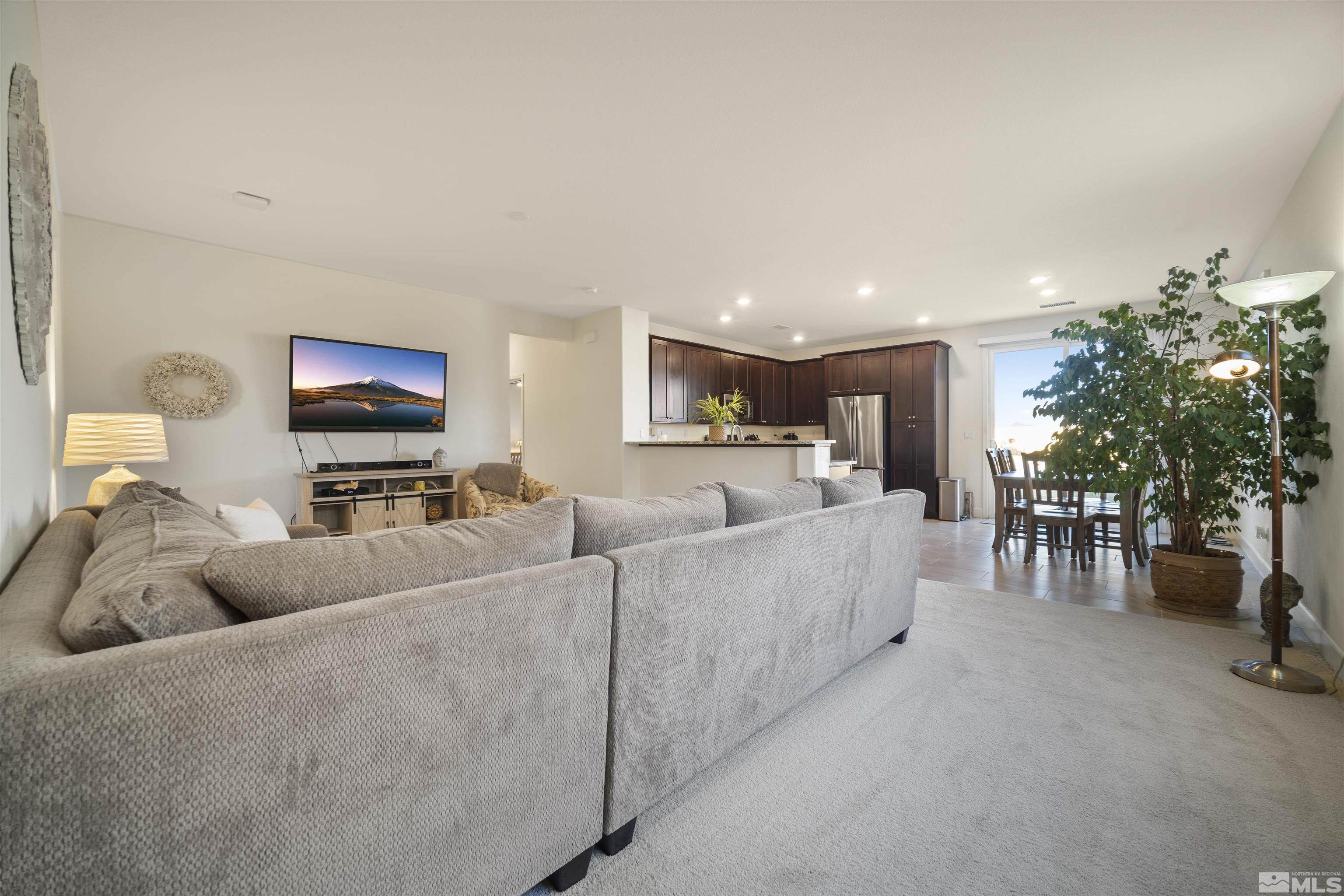 6713 Eagle Peak Drive Carson City, NV 89701 - Photo 7 of 40 a living room with furniture a dining table and a potted plant