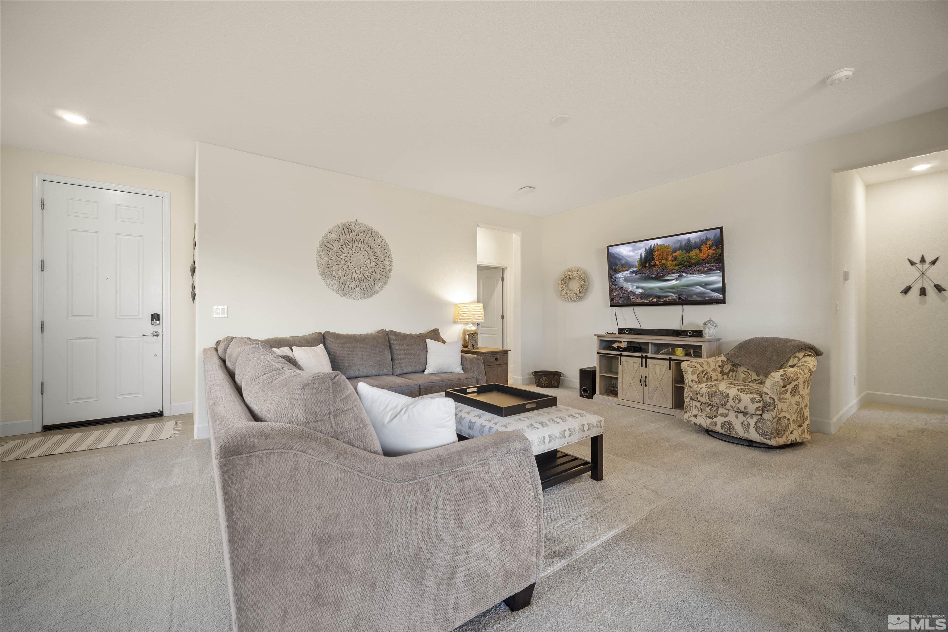 6713 Eagle Peak Drive Carson City, NV 89701 - Photo 8 of 40 a living room with furniture and a mirror