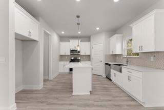 636 Bald Ridge Circle Demorest, GA 30535 - Photo 8 of 35 a large kitchen with stainless steel appliances kitchen island a sink a stove a refrigerator and a window