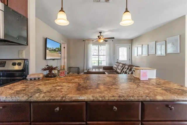 a view of a dining room with furniture and chandelier