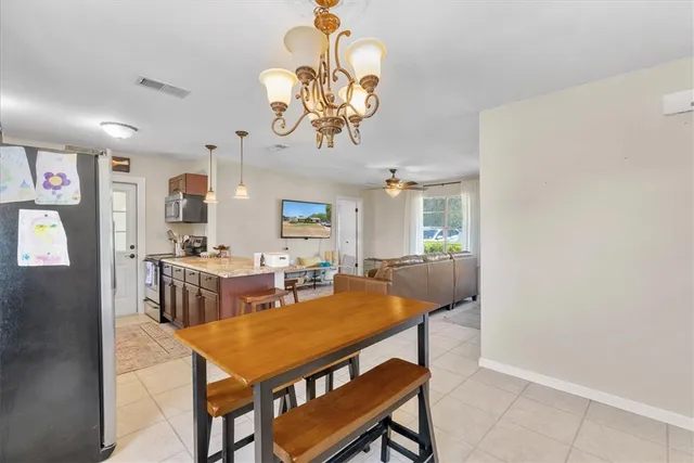 a view of a kitchen with a dining table and chandelier