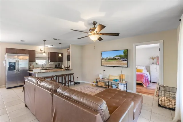a living room with furniture kitchen view and a dining table
