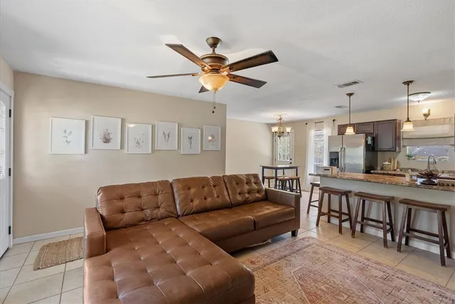 a large kitchen with kitchen island a stove a sink a dining table and chairs