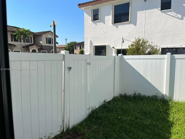 a view of hotel and yard with trees
