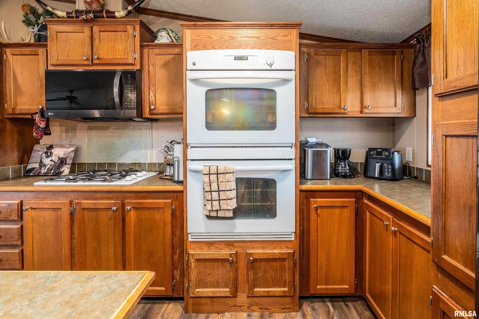 3996 Belgium Road Mulkeytown, IL 62865 - Photo 24 of 49 a kitchen with stainless steel appliances granite countertop a stove top oven a sink dishwasher and a microwave oven on the blue kitchen countertops