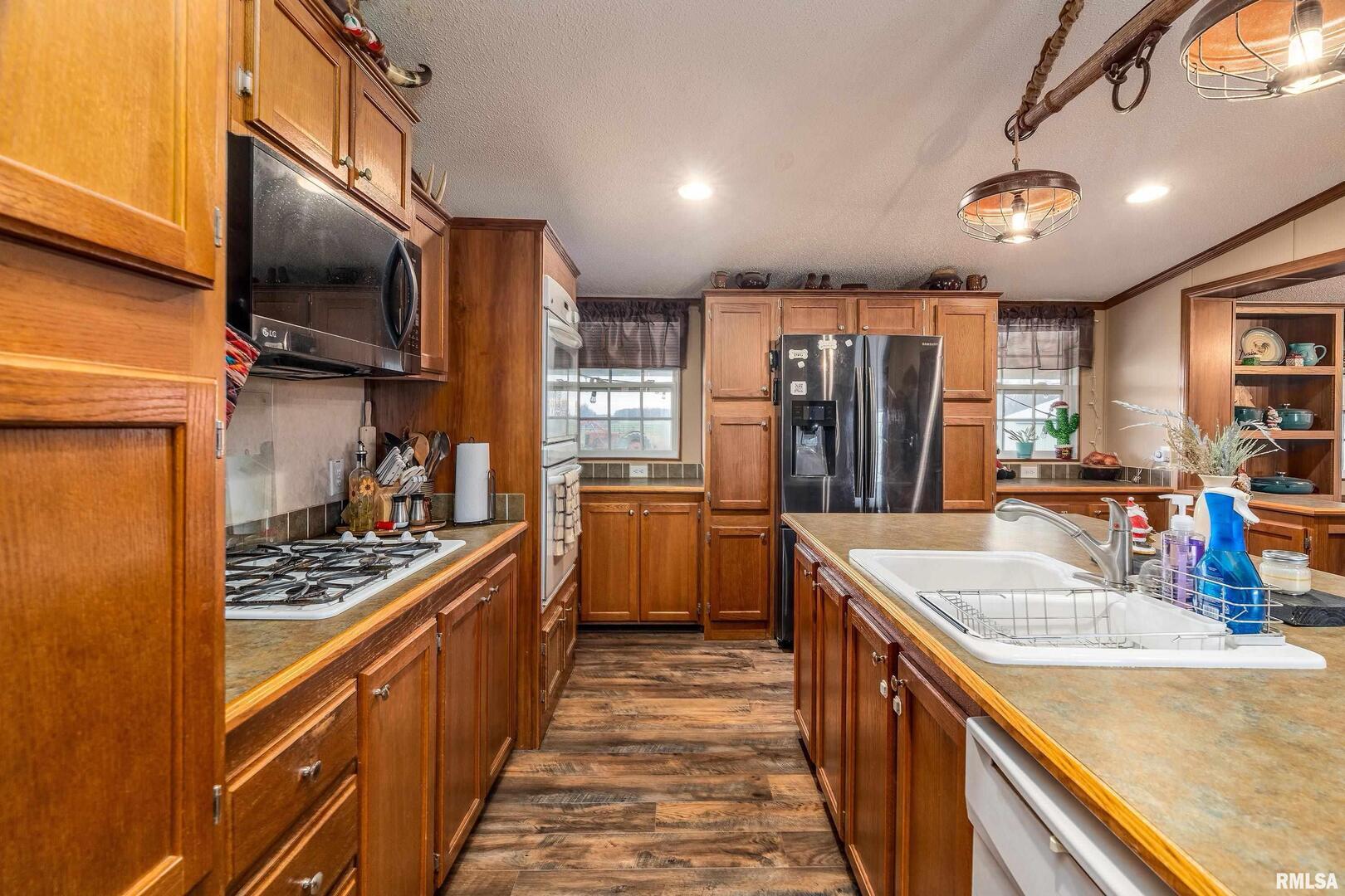 3996 Belgium Road Mulkeytown, IL 62865 - Photo 25 of 49 a kitchen with kitchen island granite countertop a sink stove and refrigerator