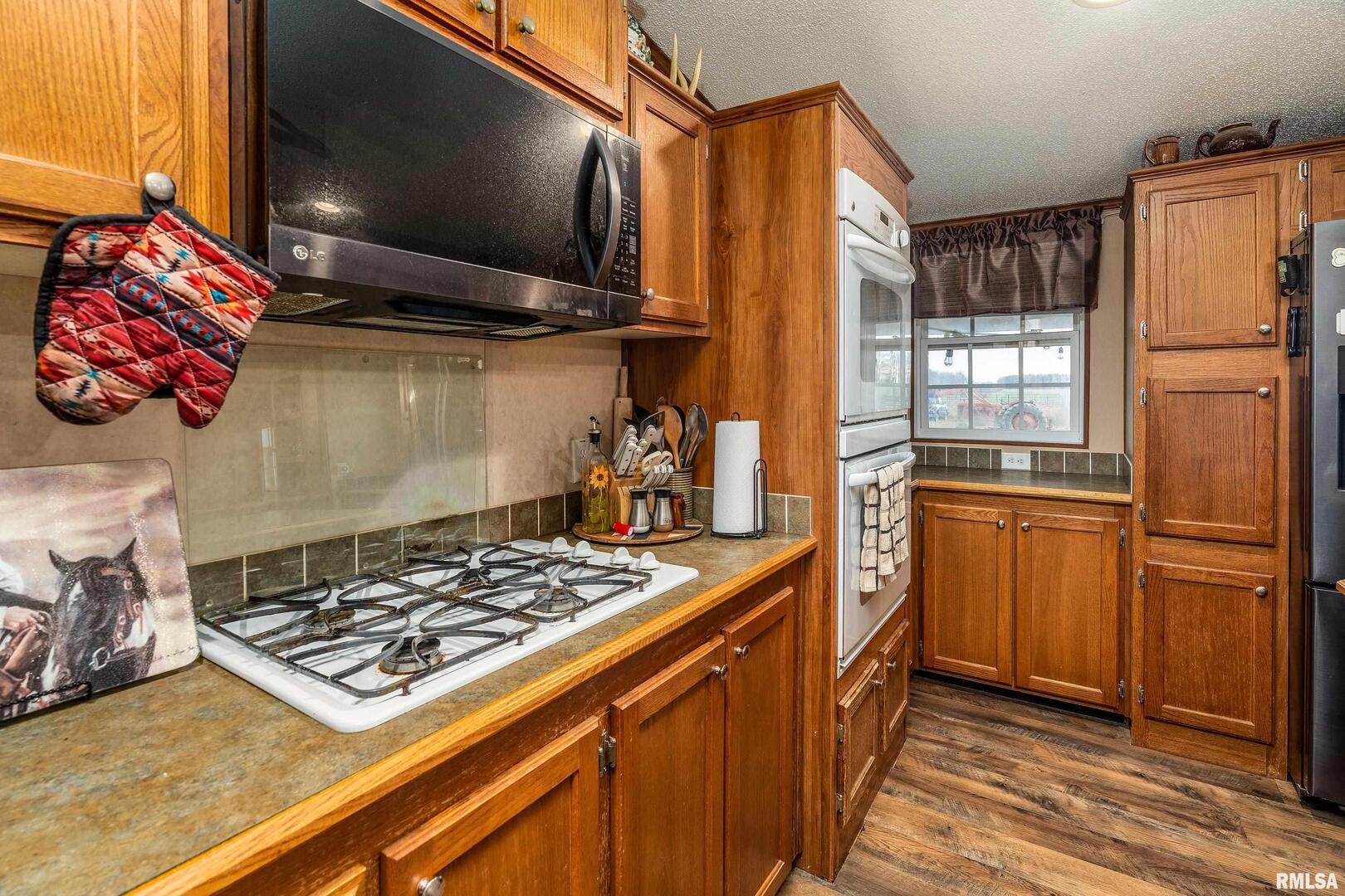 3996 Belgium Road Mulkeytown, IL 62865 - Photo 29 of 49 a kitchen with stainless steel appliances granite countertop a sink stove and refrigerator
