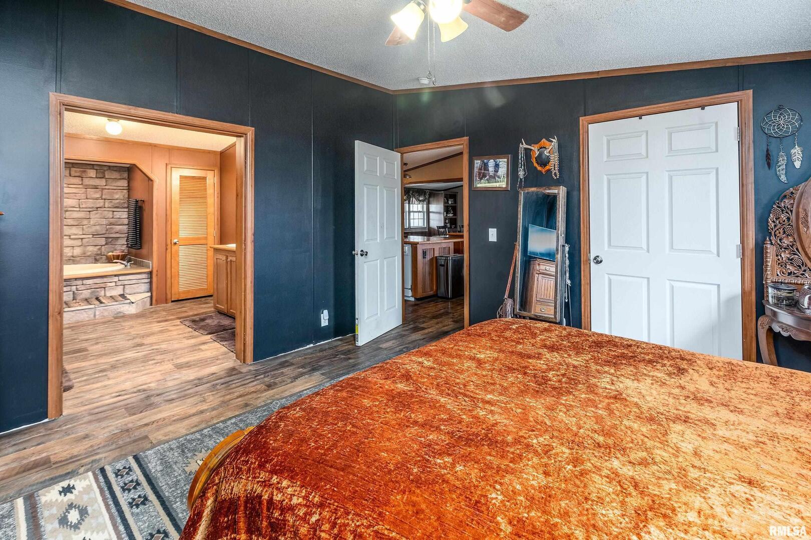 3996 Belgium Road Mulkeytown, IL 62865 - Photo 38 of 49 a bedroom with a large bed and a chandelier