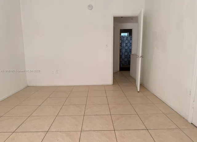a view of an empty room with closet