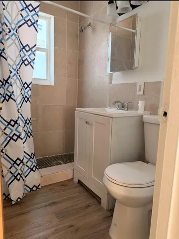 a bathroom with a toilet and a shower