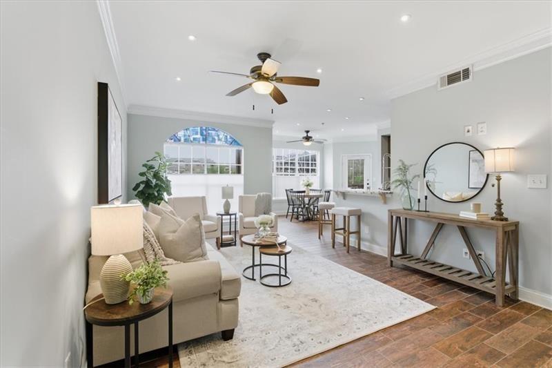 200 Renaissance Parkway Northeast, Unit 304 Atlanta, GA 30308 - Photo 1 of 40 a living room with furniture a rug chandelier and a window