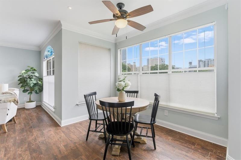 200 Renaissance Parkway Northeast, Unit 304 Atlanta, GA 30308 - Photo 15 of 40 a view of a dining room with furniture window and wooden floor