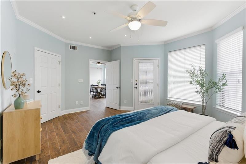 200 Renaissance Parkway Northeast, Unit 304 Atlanta, GA 30308 - Photo 17 of 40 a bedroom with a large bed and a chandelier