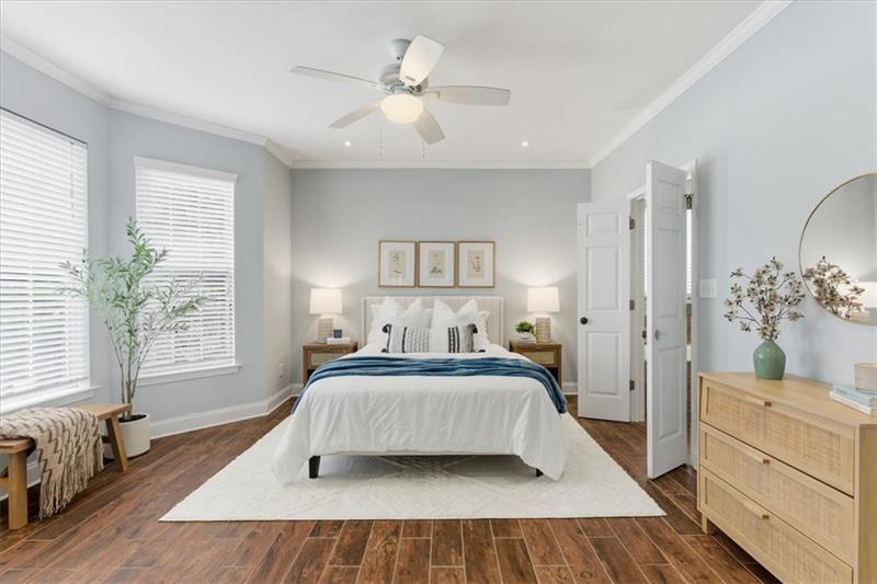 200 Renaissance Parkway Northeast, Unit 304 Atlanta, GA 30308 - Photo 18 of 40 a bedroom with a large bed and a chandelier