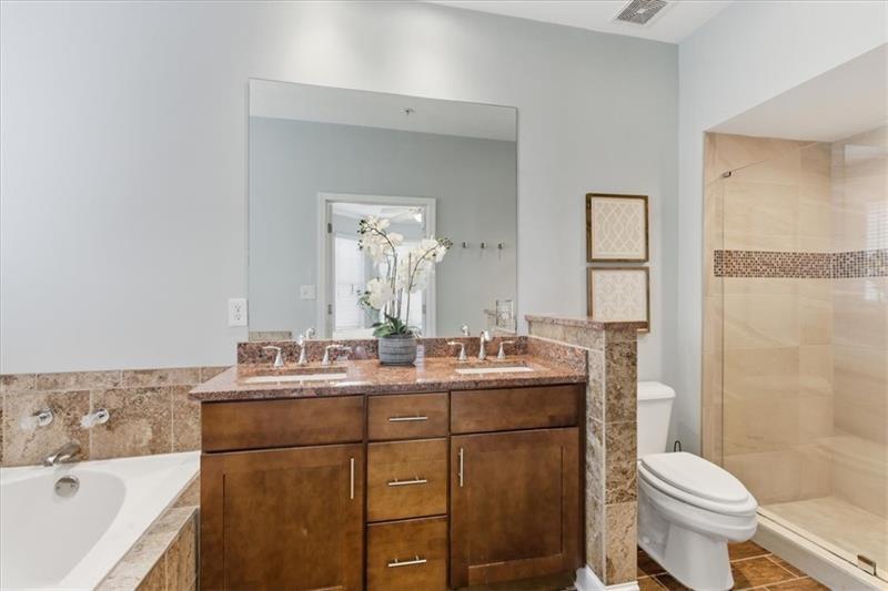 200 Renaissance Parkway Northeast, Unit 304 Atlanta, GA 30308 - Photo 19 of 40 a bathroom with a sink a toilet and shower