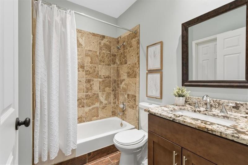 200 Renaissance Parkway Northeast, Unit 304 Atlanta, GA 30308 - Photo 23 of 40 a bathroom with a granite countertop sink toilet and shower