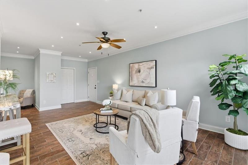 200 Renaissance Parkway Northeast, Unit 304 Atlanta, GA 30308 - Photo 3 of 40 a living room with furniture and a potted plant