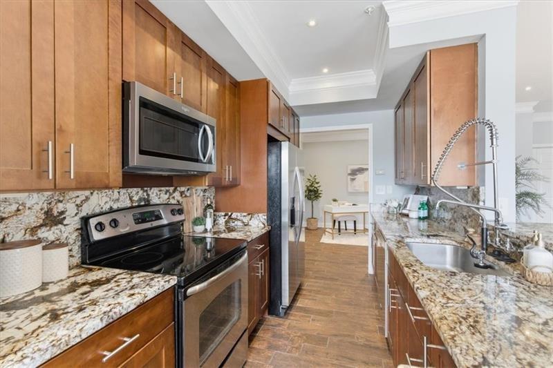 200 Renaissance Parkway Northeast, Unit 304 Atlanta, GA 30308 - Photo 10 of 40 a kitchen with a stove sink and microwave
