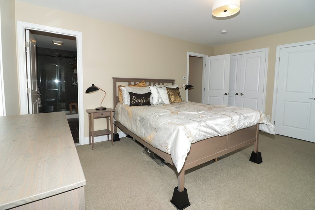 25 Eagle Nest Road, Unit 25 Clinton, MA 01510 - Photo 19 of 38 a bedroom with a bed and a table