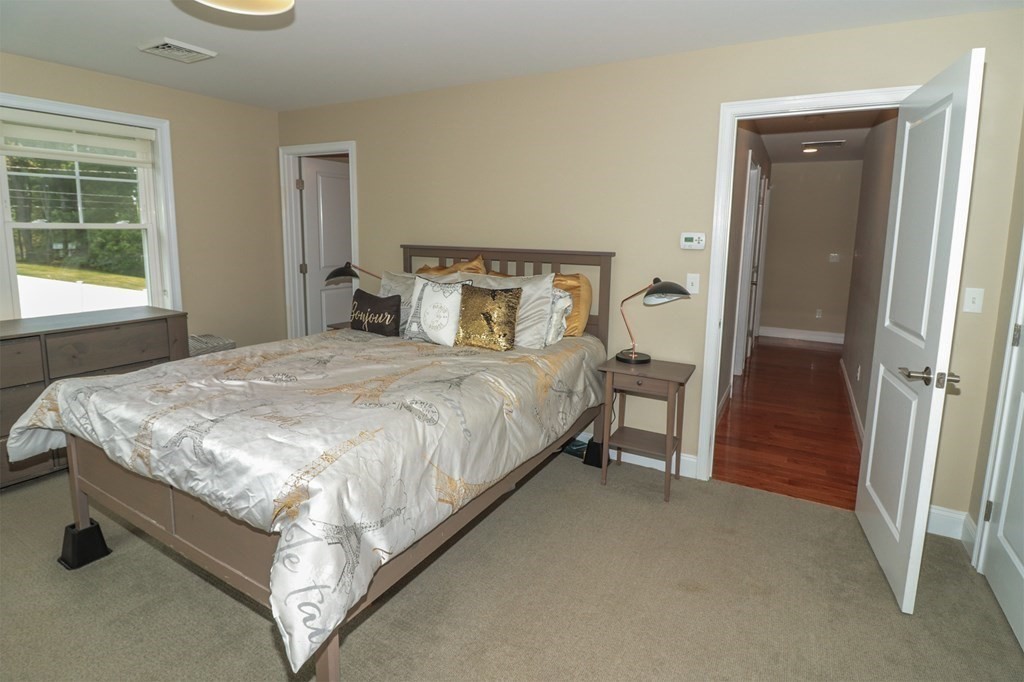 25 Eagle Nest Road, Unit 25 Clinton, MA 01510 - Photo 20 of 38 a bedroom with a bed and a table