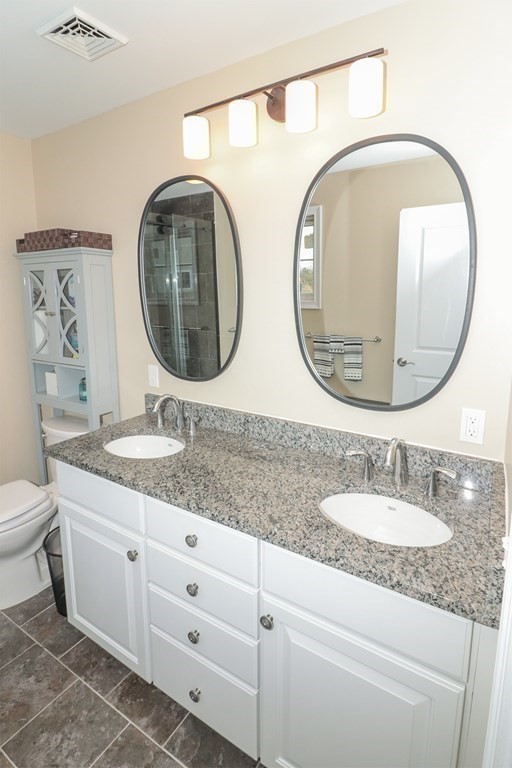 25 Eagle Nest Road, Unit 25 Clinton, MA 01510 - Photo 23 of 38 a bathroom with a granite countertop double vanity sink and a mirror